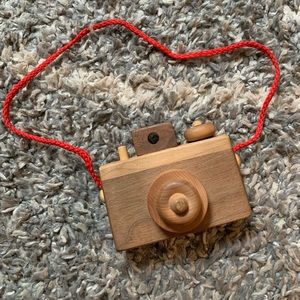 Handmade wooden camera with red strap